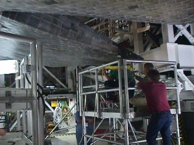 Workers adjusting the elevons of Discovery's right wing