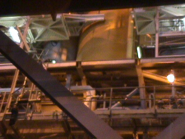 To the left of the fuel tank is one of Atlantis' white recoverable booster rockets prior to STS-106