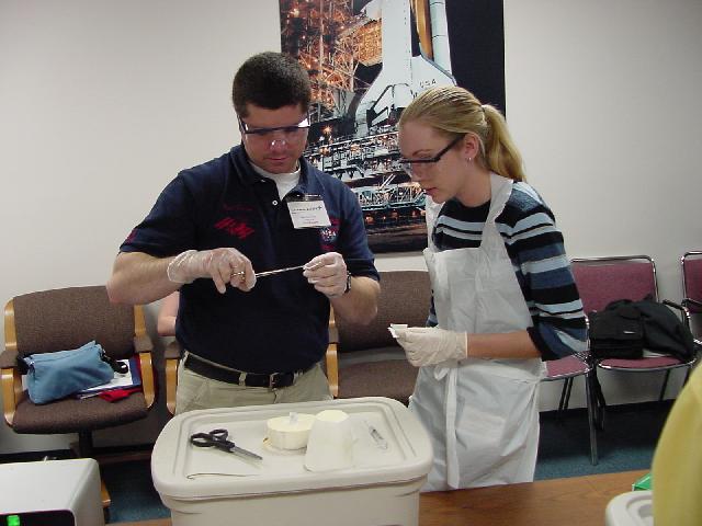 Paul Dixon shows student how to handle a flight sample tube