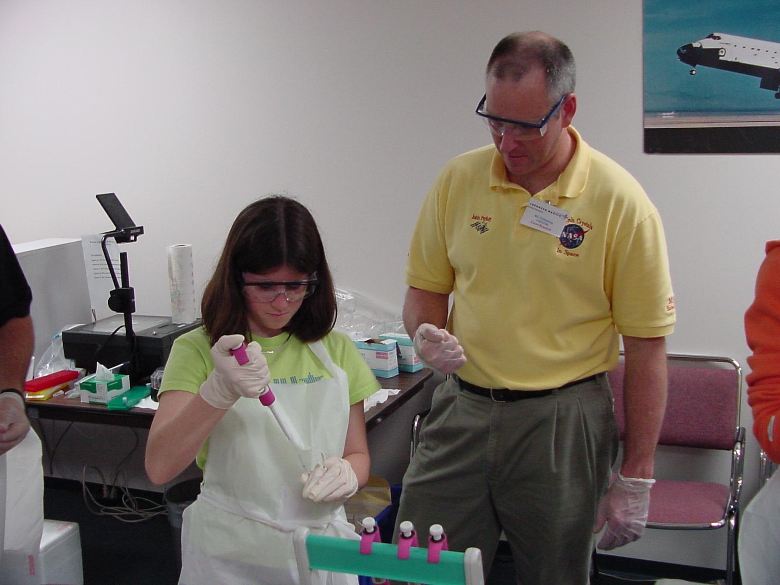 John Perkey helps student with the adjustable pipetter